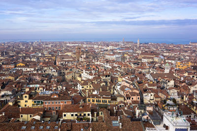 Cityscape against cloudy sky