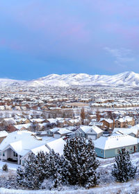 Buildings in town against sky during winter