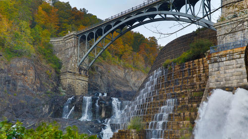 Low angle view of arch bridge over stream