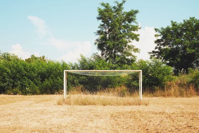 Goal post on field against sky