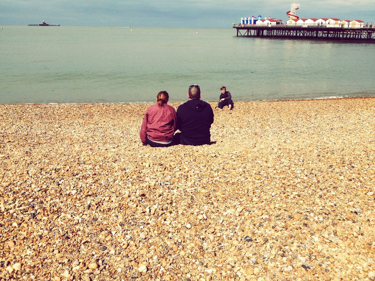 sea, water, beach, lifestyles, leisure activity, shore, men, relaxation, sand, vacations, person, sitting, togetherness, horizon over water, sky, tourist, full length, nature