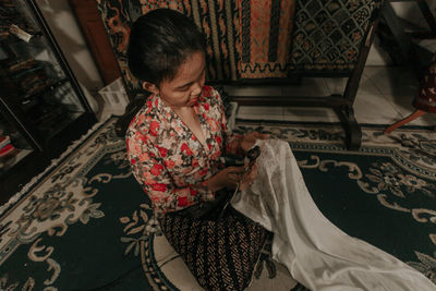 High angle view of woman working in textile workshop