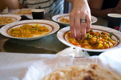 Close-up of hand holding food on table