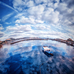 Man on boat in sea against sky