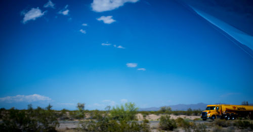 Scenic view of landscape against blue sky