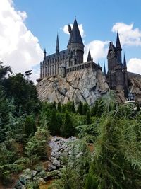 Castle and trees against sky