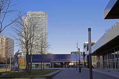 Modern buildings against clear blue sky