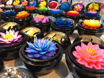 Close-up of multi colored artificial flowers on table at store