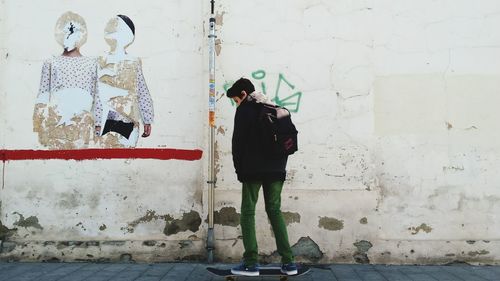 Full length of woman standing on wall