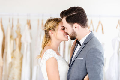 Couple holding hands while standing on field