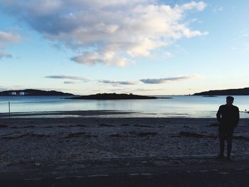 Silhouette of people standing on beach