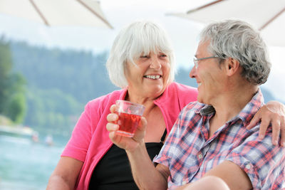 Close-up of happy friends drinking water