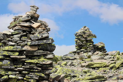 Low angle view of stone stack against sky
