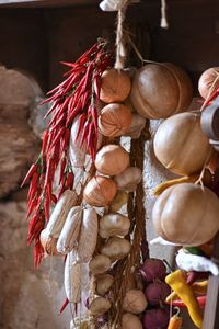 Close-up of red chili peppers hanging at market stall