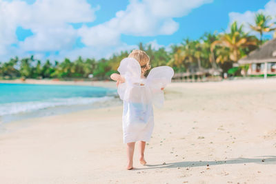 Full length of girl standing on beach