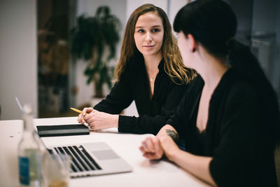 Business people discussing at desk in office