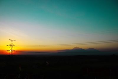 Silhouette landscape against sky during sunset