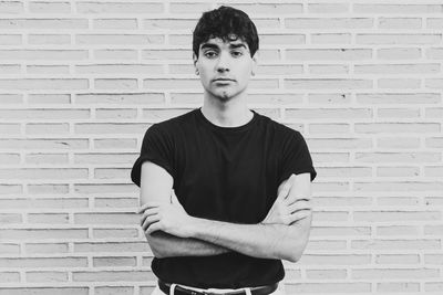 Portrait of boy standing against wall