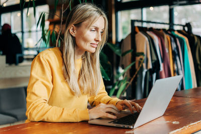 Young woman using laptop at table