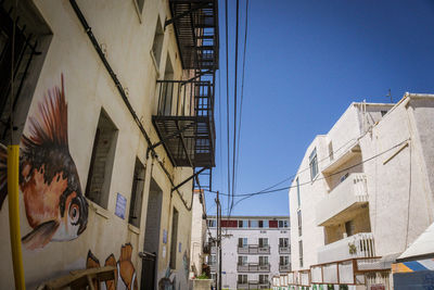 Low angle view of buildings against blue sky