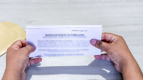 Midsection of person holding book