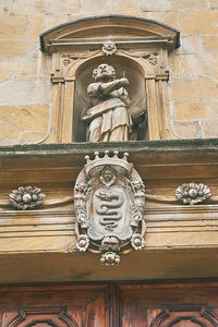 Low angle view of statue against building