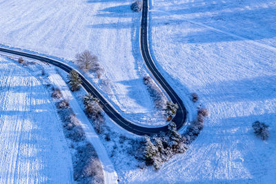 Aerial winter landscape. road leading through snowcapped winter forest. aerial view. 