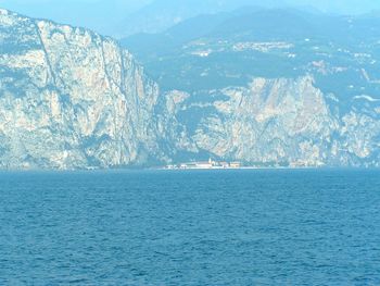 Scenic view of sea and snowcapped mountains against sky