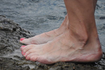 Low section of person legs in sea