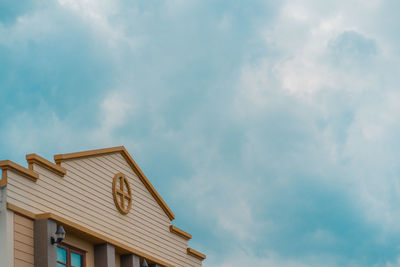 Low angle view of building against cloudy sky