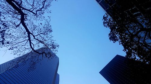 Low angle view of buildings against clear blue sky