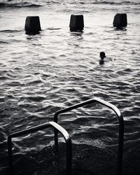 High angle view of wooden posts in sea