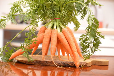 Close-up of carrots on cutting board over table