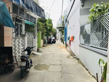 Footpath amidst buildings in city