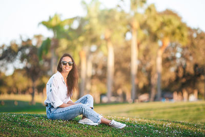 Young woman sitting on field