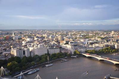 Aerial view of city by sea against sky