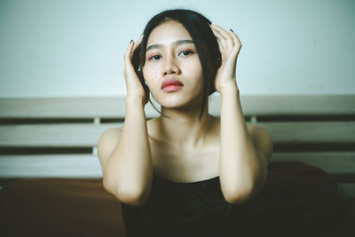 Portrait of young woman sitting at home