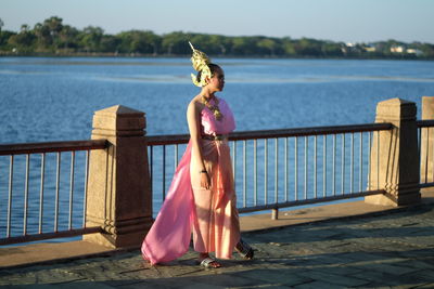 Full length of woman wearing traditional clothing standing on footpath