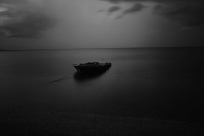 Boat moored on sea against sky