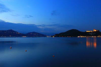 Scenic view of lake against sky at dusk