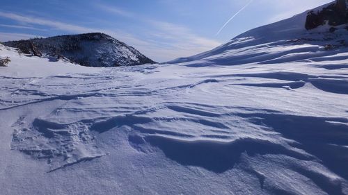 Snow covered field against sky