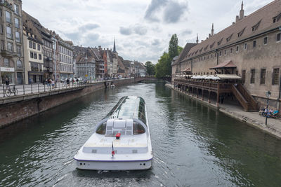 Boats in river against sky