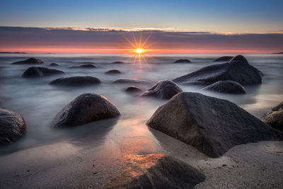 Scenic view of sea against sky during sunset