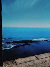 Scenic view of sea against clear blue sky