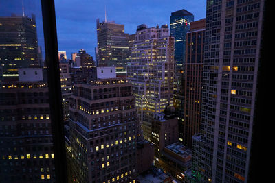 Aerial view of illuminated buildings at night in new york city