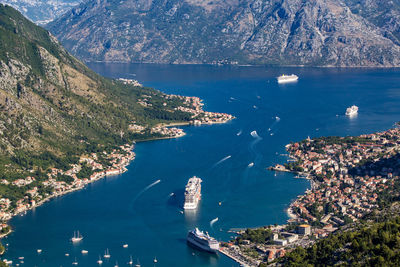 High angle view of kotor townscape and mountains against sky