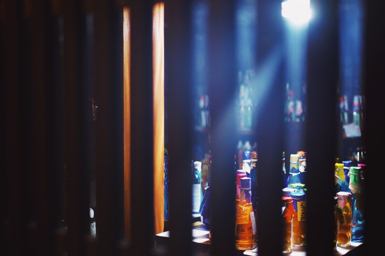 indoors, no people, container, food and drink, bottle, refreshment, glass - material, night, nightlife, still life, drink, close-up, selective focus, bar - drink establishment, glass, window, alcohol, illuminated, nightclub, bar counter