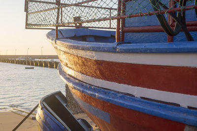 Close-up of ship moored on sea against sky