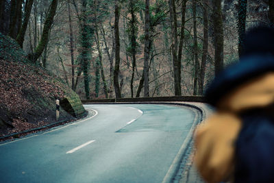 Road amidst trees in forest