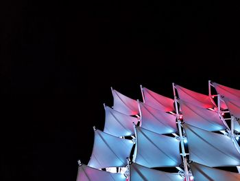 Low angle view of flags against clear sky